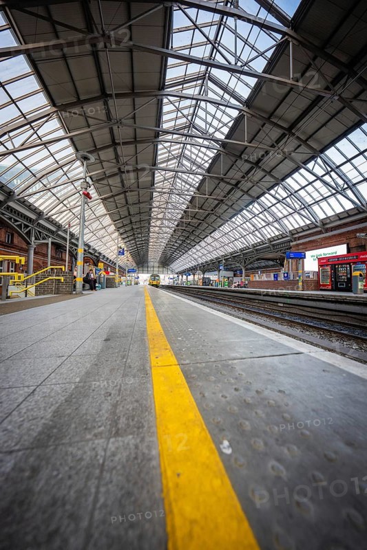 An empty train station with a long roof and tracks in urban architecture, Dublin, Ireland