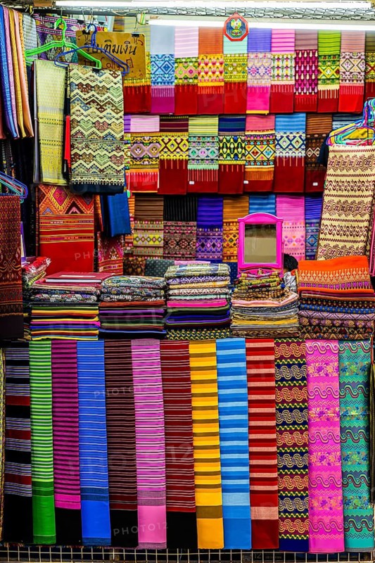 Colourful cloths lined up in a fabric shop, Kad Luang Warorod Market, Chiang Mai Thailand