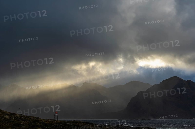 Sunbeams over coastal landscape and sea, Lofoten, Nordland, Norway, September 2020