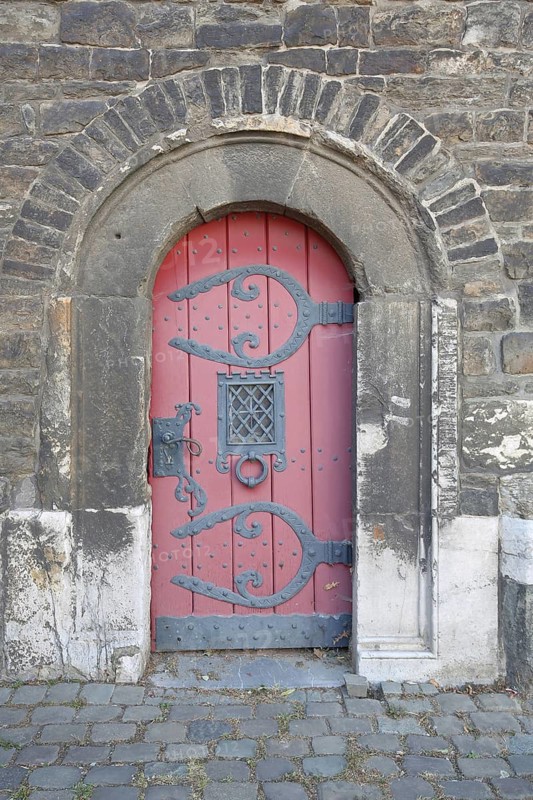 Semicircular red wooden door with fittings built at Ponttor 14th century, city tower, city gate, old town, Aachen, Eifel, North Rhine-Westphalia, Germany