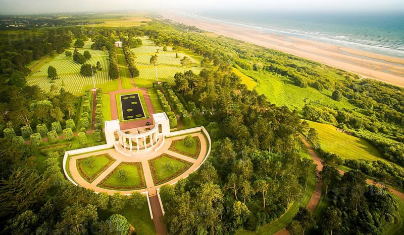 Aerial view to dramatic normandy coast with memorial to dead american soldiers of WW2.Omaha cemetery. France