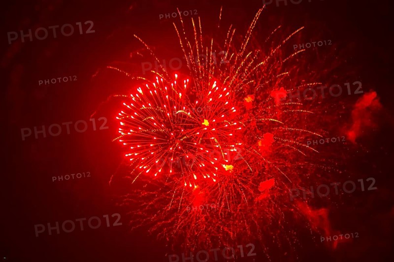 Red fireworks illuminate the night sky, Ternitz, Lower Austria, Austria