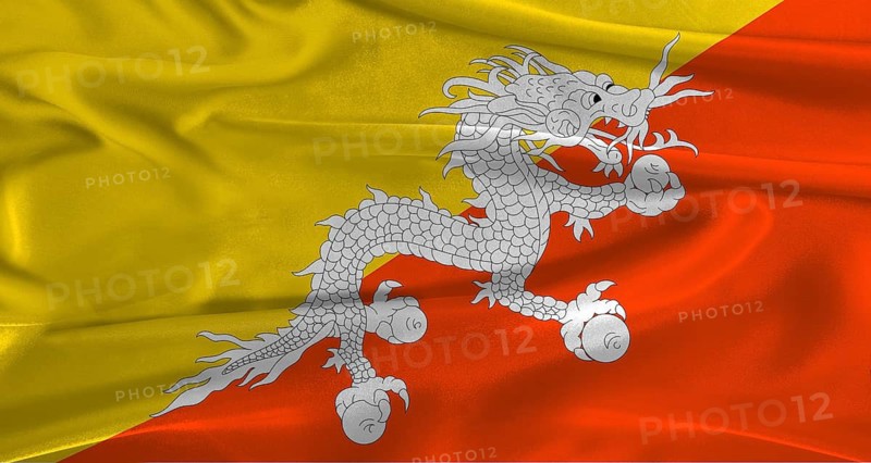 Flag of Bhutan with fabric textured background. Close up of National flag of Bhutan with realistic texture
