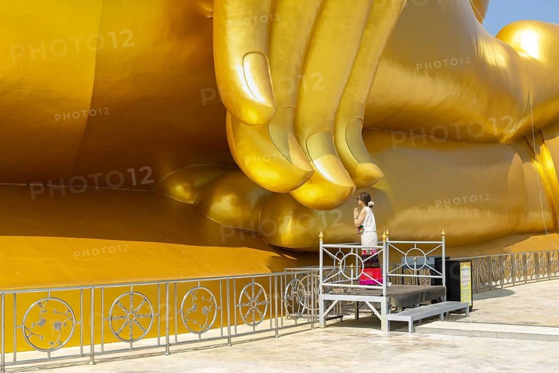 Largest Buddha statue in Thailand (Luang Pho Yai), Thai woman, Wai gesture (traditional gesture of respect, greeting or thanks), Wat Muang, Ang Thong, Amphoe Wiset Chai Chan province, Thailand