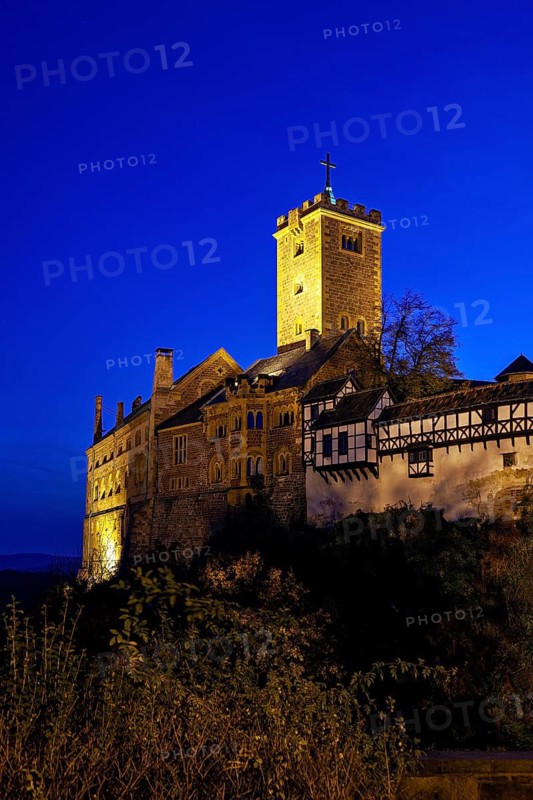 Illuminated castle at night with a visible tower and mysterious atmosphere, The Wartburg near Eisenach in Thuringia