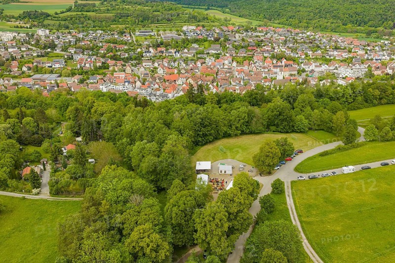 City with adjacent forest and meeting area with tents, Father's Day, Forest Festival, Aidlingen, Böblingen district, Germany