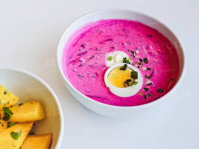 A bowl of popular Lithuanian cold beetroot soup Saltibarsciai or cold borscht with baked potato wedges
