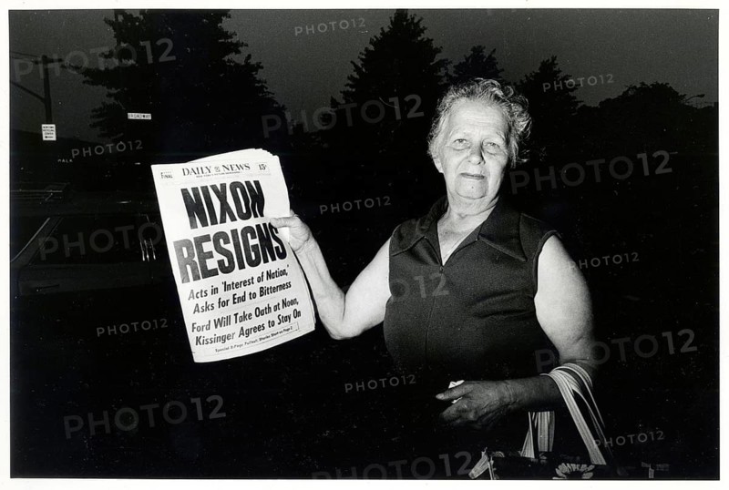 Richard Nixon, president, USA, resignation, August 9, 1974, Watergate, affair, night, special issue, Daily News, woman holding a newspaper with the headline 'Nixon Resigns' in darkness, 1974