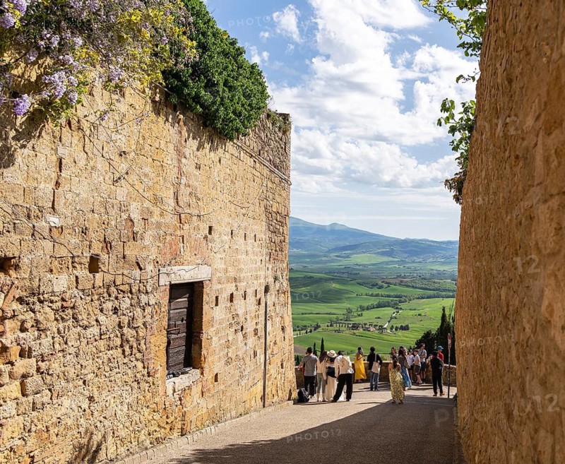 Tourists traveling in the small town of Pienza in Tuscany, Italy