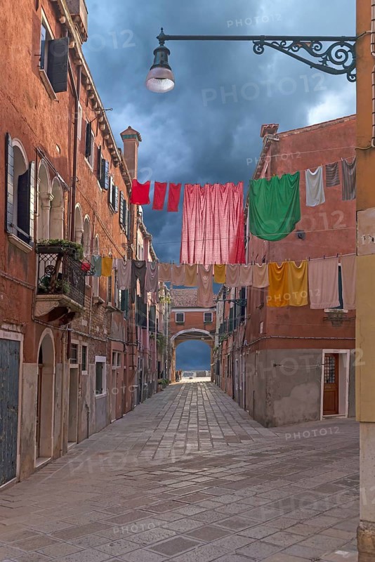 Colourful laundry stretched on linen between houses, Castello district, Venice, Veneto, Italy