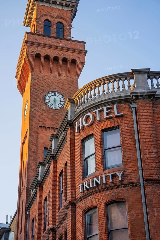 Hotel building with clock tower in golden light, architectural details, Dublin, Ireland