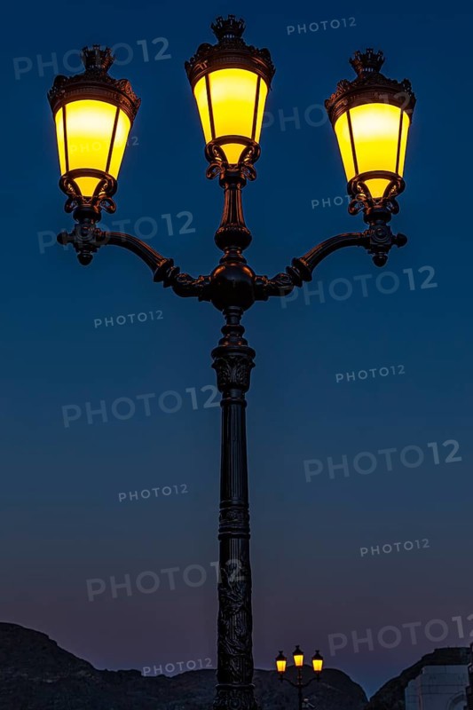 Three-flame, illuminated candelabra lamp, at the Sultan's Palace, Muscat, Arabian Peninsula, Sultanate of Oman