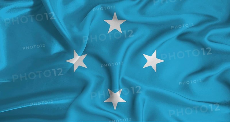 Realistic Micronesia flag waving. Close up of flag of Micronesia with cloth texture