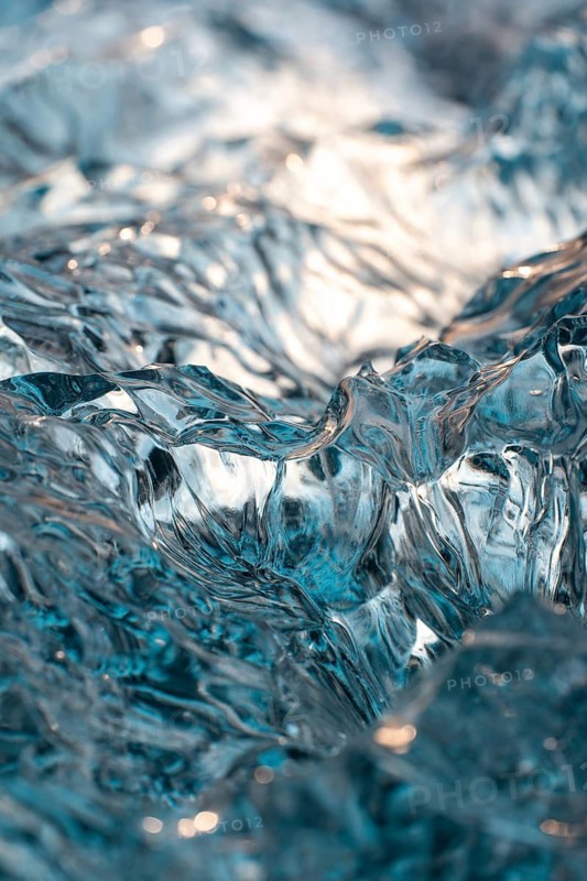 Close-up shot showcasing intricate, translucent ice formations on Diamond Beach, Iceland. Captures the serenity and beauty of winter with stunning clarity and texture