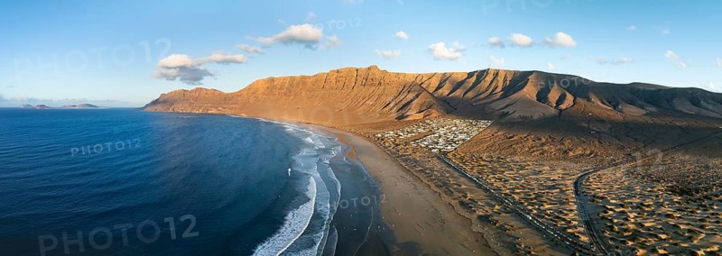 Panorama, Risco de Famara cliffs and sea with Famara beach, in the evening light, Playa de Famara, aerial view, Lanzarote, Canary Islands, Spain