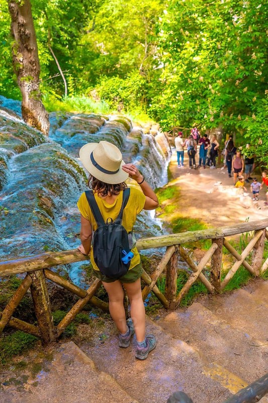 A female tourist walking among waterfalls in the Monasterio de Piedra Natural Park, Aragon