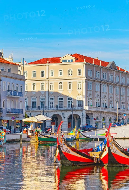 View of moliceiro boats floating on Aveiro river main lagoon, Aveiro, Portugal