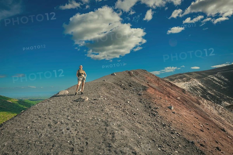 Lifestyle of girl at the summit of the Cerro Negro volcano. Portrait of a female tourist at the summit of the Cerro Negro volcano