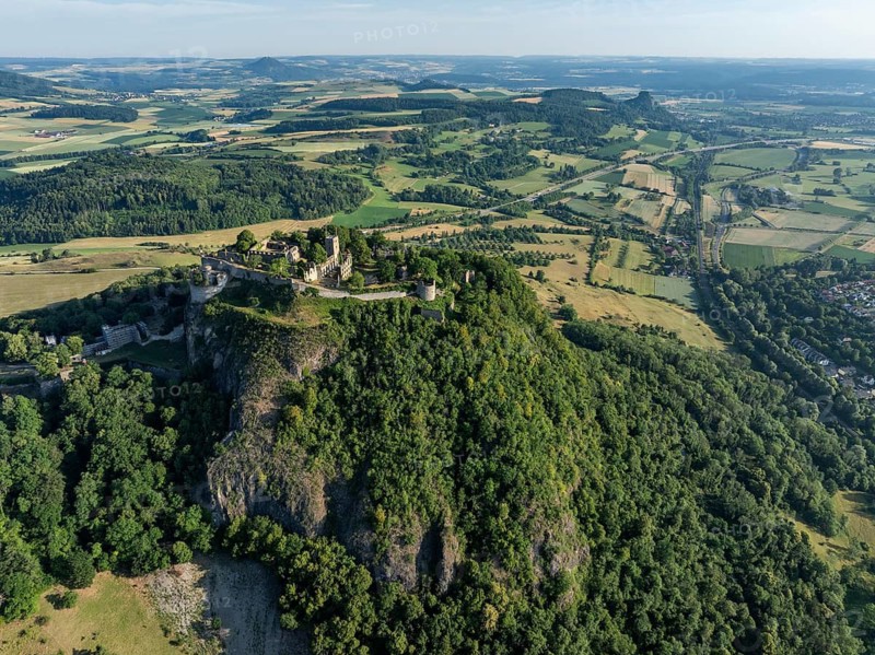 Aerial view of the Hohentwiel volcanic cone with Germany's largest fortress ruin, in the morning sun, a tourist attraction in the Lake Constance region, seen on the horizon from the left the Hegauberge Hohenhewen, Mägdeberg and Hohenkrähen, Hegau, Konstanz district, Baden-Württemberg, Germany