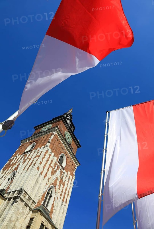 Town Hall Tower on the Main Market Square in Krakow, surrounded by Polish national colors, flags, Poland