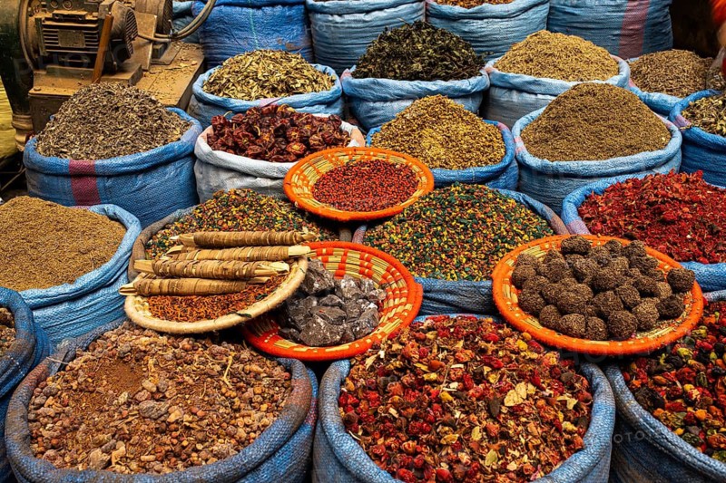Dried scented flowers, spices and medicinal herbs for sale are on display at a sales stand, spice dealer, quack, herborist, souk, bazaar, Marrakech, Maghreb, Morocco, North Africa