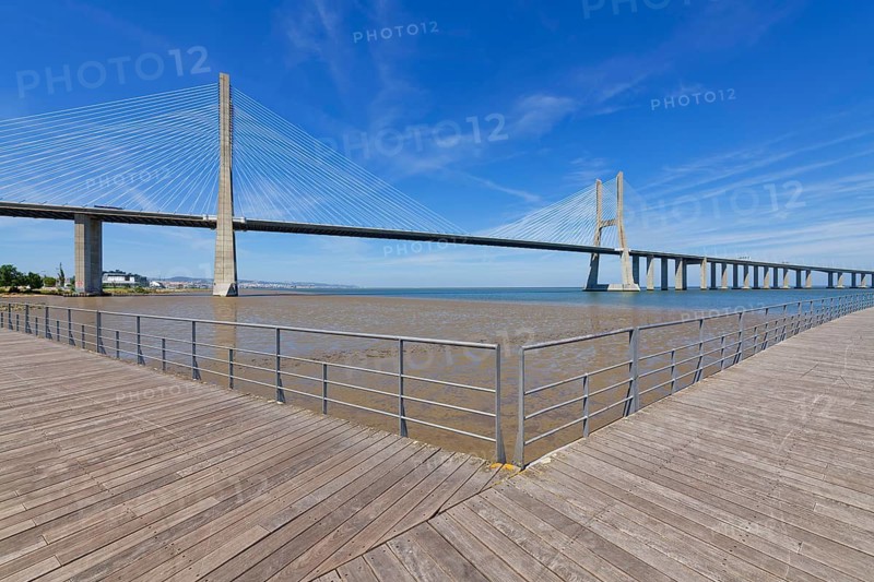 Boardwalk over Tagus River in front of the Cable-stayed Vasco da Gama Bridge, Lisbon, Portugal
