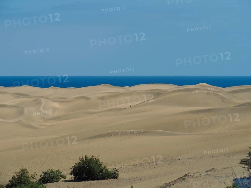 Infinite sand stretches to the blue sea, dunes of Maspalomas, Gran Canaria, Spain