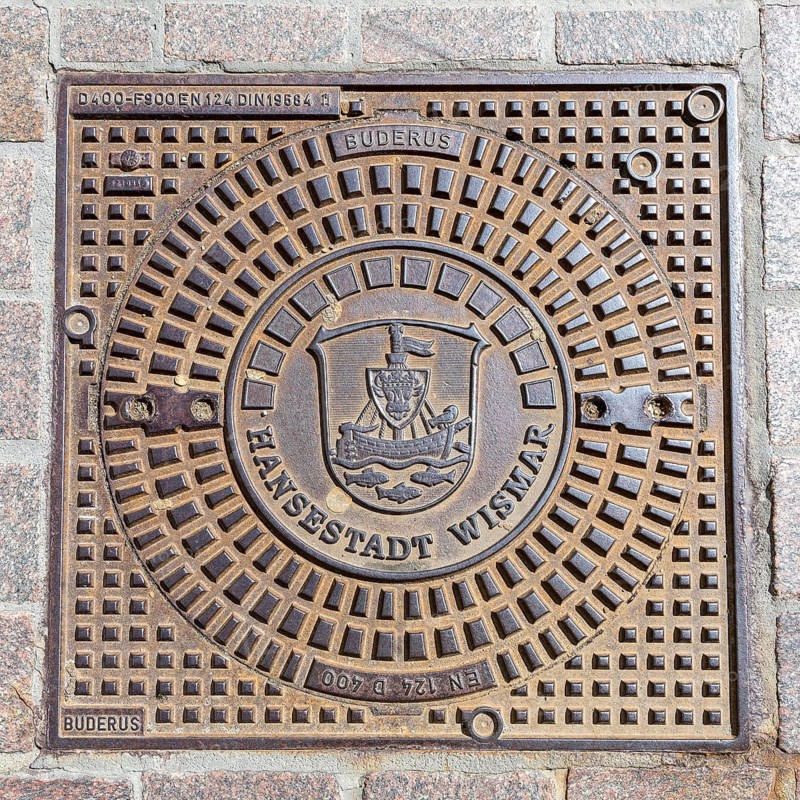 Manhole cover with coat of arms of the Hanseatic City of Wismar, Mecklenburg-Western Pomerania, Germany
