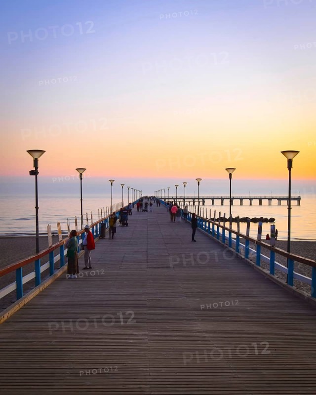 Dramatic colorful sunset at famous marine pier in Baltic resort city of Palanga. Lithuania