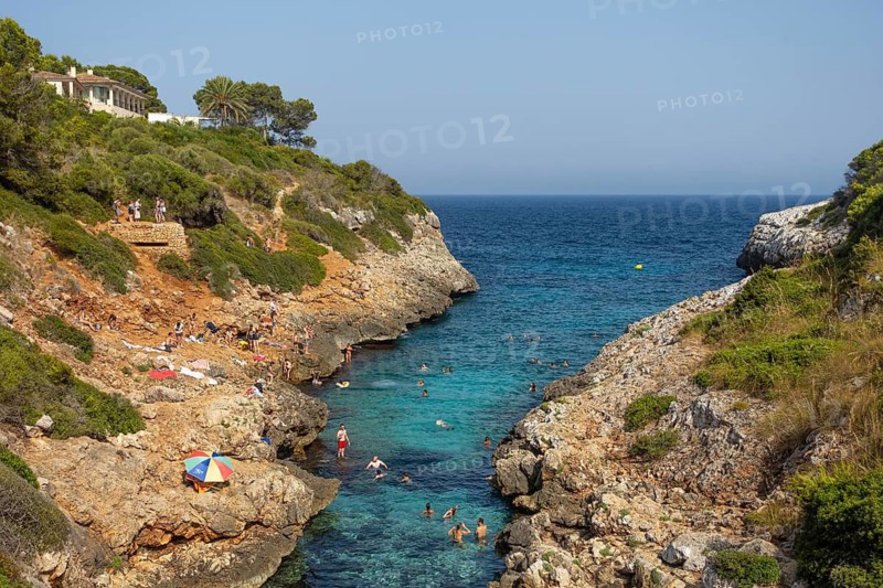 People bathe in Cala Muta Bay in Majorca, Cala Muta, Porto Cristo, Majorca, Spain