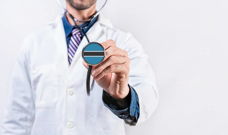 Botswana healthcare system, doctor holding stethoscope. Botswana health and medical insurance concept