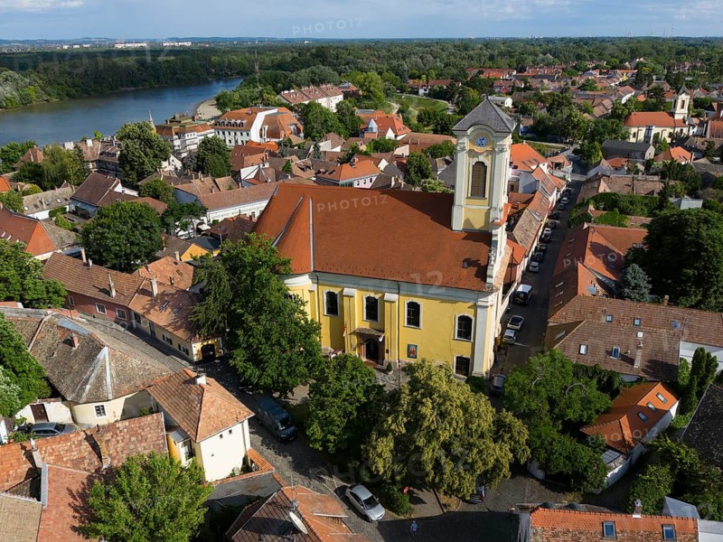 City view with a church in the center, surrounded by green trees, near a river, aerial view, St. Peter and Paul church, Szentendre, Sankt Andrä, Danube river, Pest County, Central Hungary Region, Hungary