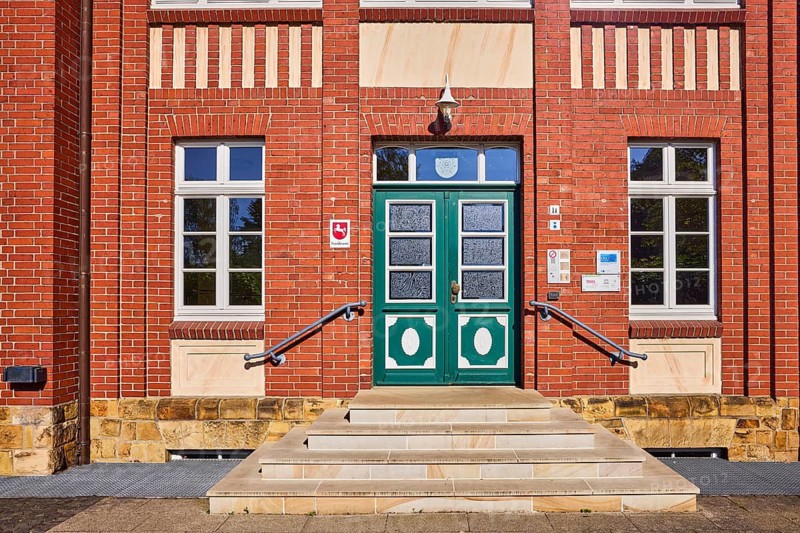 Registry office, brick building, brick architecture, façade with windows and door, entrance, staircase, coat of arms of Lower Saxony with horse, sunny, Hasestraße, Bramsche, Osnabrück district, Lower Saxony, Germany