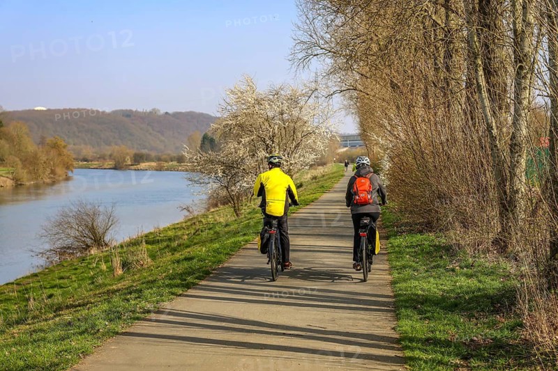 Hattingen, North Rhine-Westphalia, Germany - Ruhr countryside, cyclists on the Ruhr promenade Winz-Baak with Ruhr Valley Cycle Path