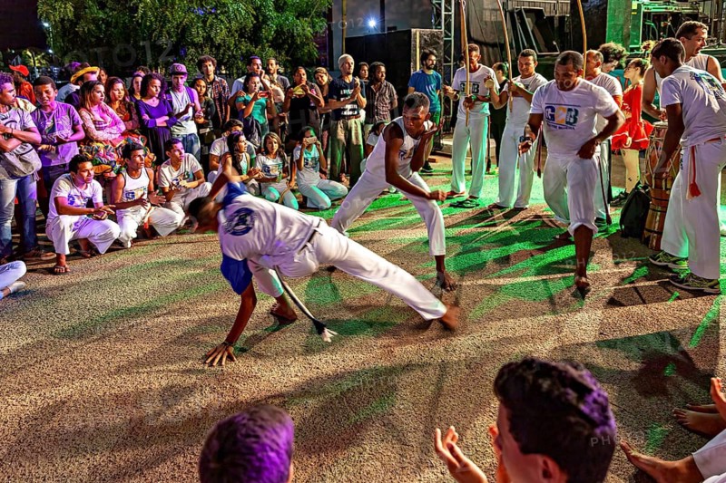 Two capoeira players in interactive movements surrounded by a fascinating crowd, The Capoeira battle dance at a small festival in Petrolina Brazil
