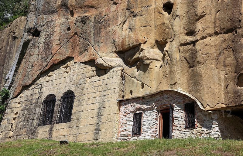 Corbii de Piatra rock monastery, stone ravens carved into a massive, 30-meter high sandstone wall, village of Jgheaburi, municipality of Corbi, in the district of Argesin, Wallachia, Romania