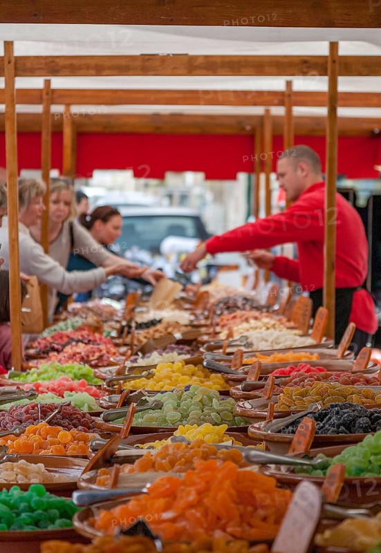 A lively market day with colorful sweets, where people shop at wooden stalls, Majorca, Balearic Islands, Spain