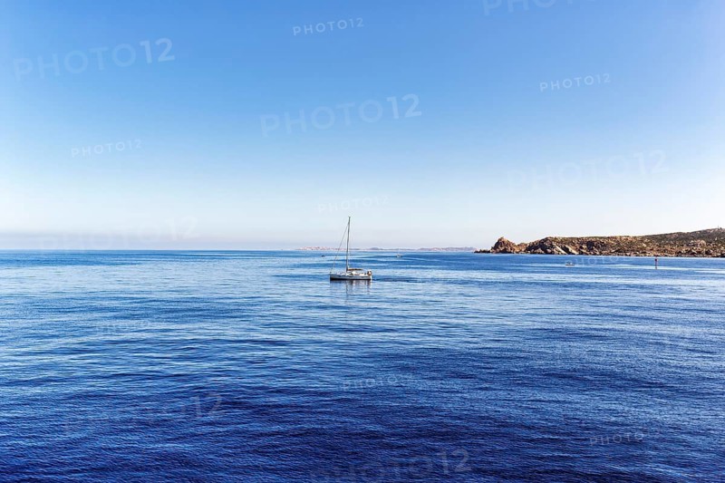 Sailing boat, Strait of Bonifacio, deep blue Mediterranean Sea, granite rocks, coastline near Santa Teresa Gallura, Sardinia, Italy