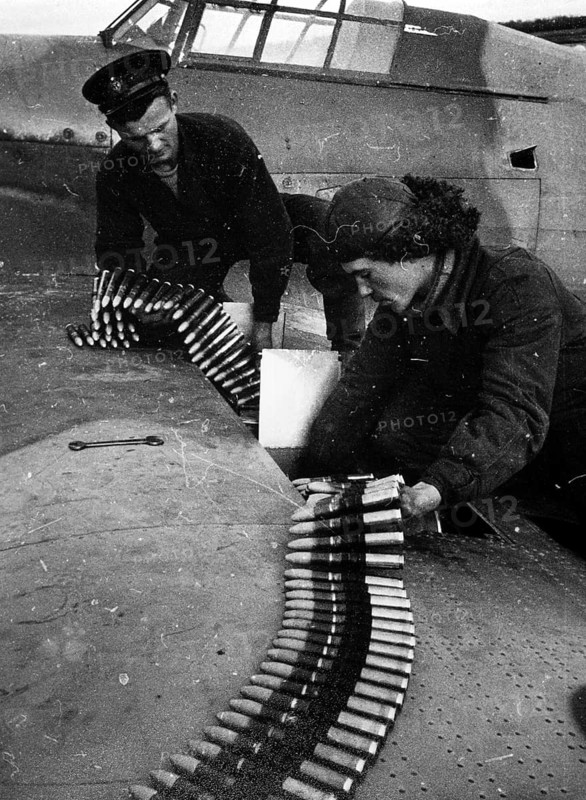An English and a Russian pilot check the fighter pilot's cartridges. Northern Front, Murmansk, Soviet Union 1941