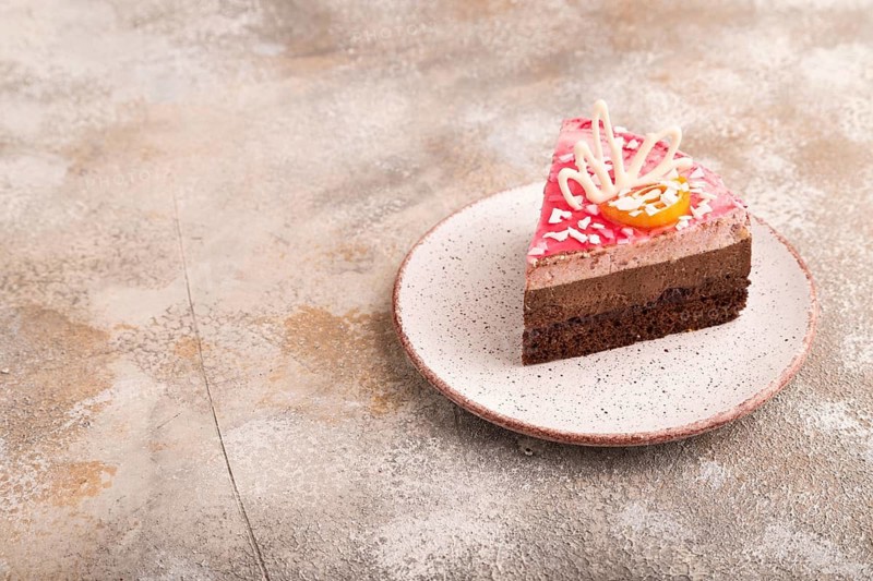 Chocolate cake on brown concrete background, side view, copy space
