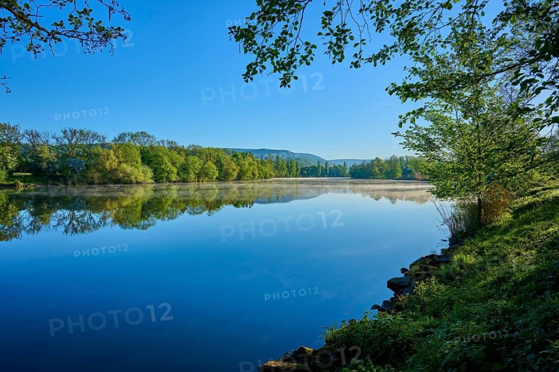 A wide view of a river with surrounding trees and clear skies, the calm water reflecting the sky, Boxtal, Main-Boxtal, Tauber district, Baden-Württemberg, and Stadtprozelten, Dorfprozelten, Main, Spessart, Bavaria, Germany