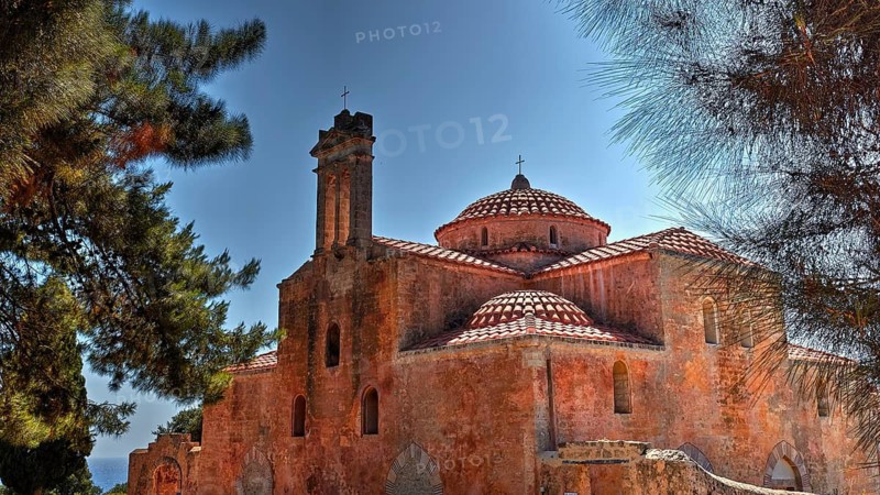 Metamorphosi tou Sotiriou Church, An old brick church surrounded by trees under a clear sky with distinctive domes, fortress, Neokastro, Pylos, Peloponnese, Greece