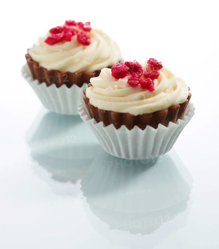 Two muffins in front of a white background, studio shot