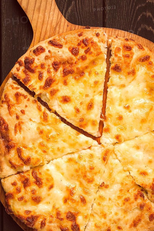 Imereti khachapuri, Traditional Georgian dish, flatbread with cheese, top view, no people, rustic