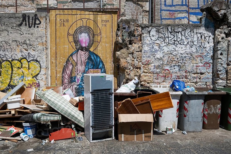 Deserted street with artistic Christ graffiti and trash, Palermo, Sicily, Italy