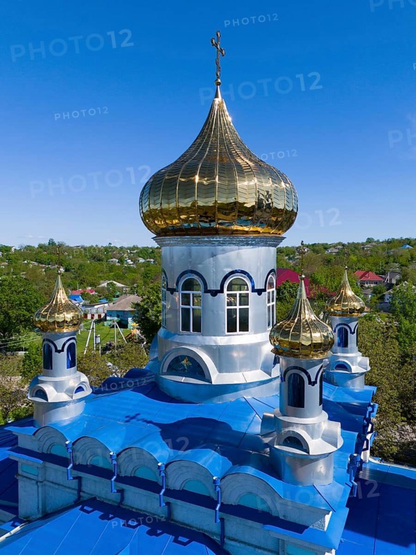 Detailed view of a golden dome on a blue roof under a blue sky, aerial view, Orthodox church, Biserica de iarna, iarna, Tareuka, Tareuca, Rezina district, Republic of Moldova, Moldova