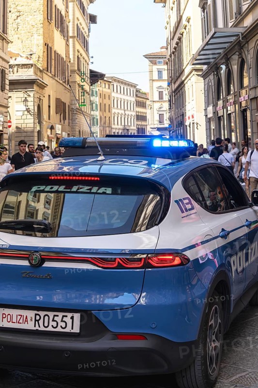 Police vehicle with flashing lights in the alleys of Florence, Tuscany, Italy