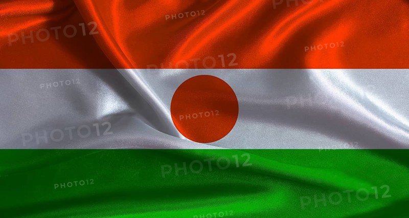 Niger flag with cloth textured background. National flag of Niger with realistic texture