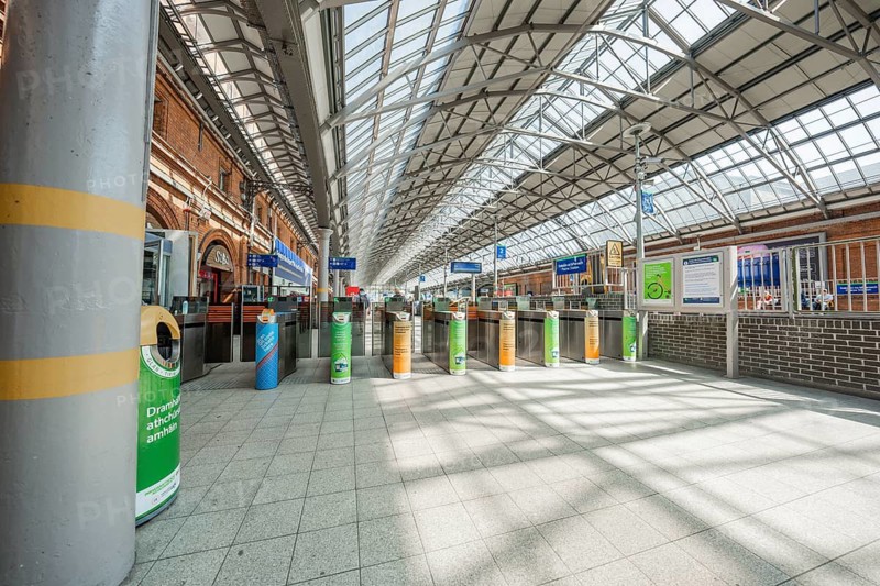 Bright interior of a train station with modern glass roof and entrance area, Dublin, Ireland