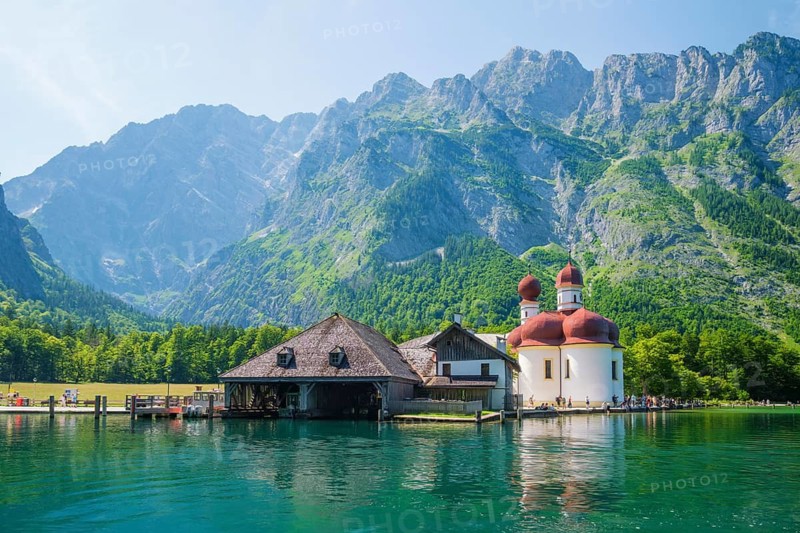 A peaceful summer day at St. Bartoloma church on the banks of Konigsee lake, showing the traditional pilgrimage site in Berchtesgaden National Park, Bavaria, Germany